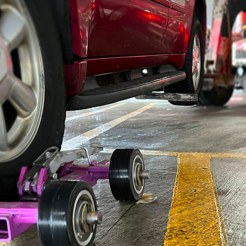 Towing car with wheel lift attachment underground parking